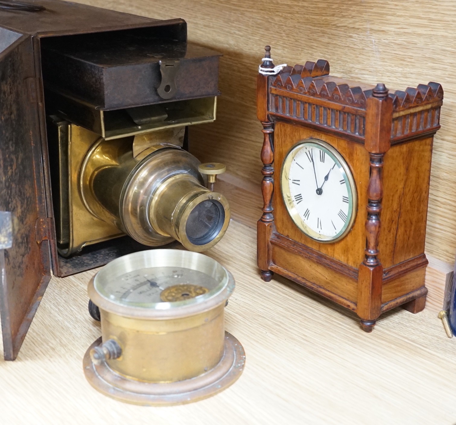 A cased tinplate and pressed brass Magic Lantern, Case 46 cm long, A French walnut cased mantel timepiece, with key, 23cm, and a brass cased Milli-Amps scale